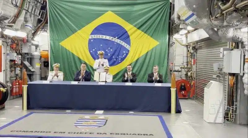 Cerimônia militar com bandeira do Brasil ao fundo.