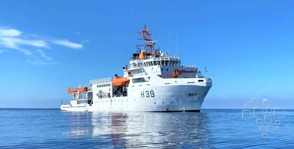 Navio branco navegando em mar calmo sob céu azul.